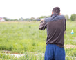 © donikz - Young man shoots air rifle in nature