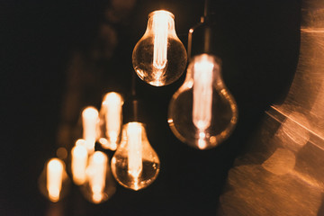 Electric yellow light bulbs on the street at night. Bulbs on the garland outsidoor.