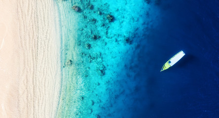 Wall Mural - boat on the water surface from top view. turquoise water background from top view. summer seascape f
