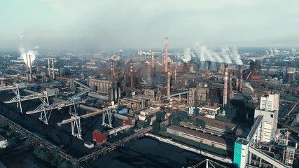 Wall Mural - Industrial zone landscape aerial view with smoke from metallurgical factory or plant chimneys. Air and environment pollution, global warming