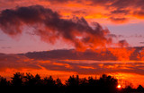 Fototapeta Niebo - Fiery orange sunset  colorful and speckled  clouds.