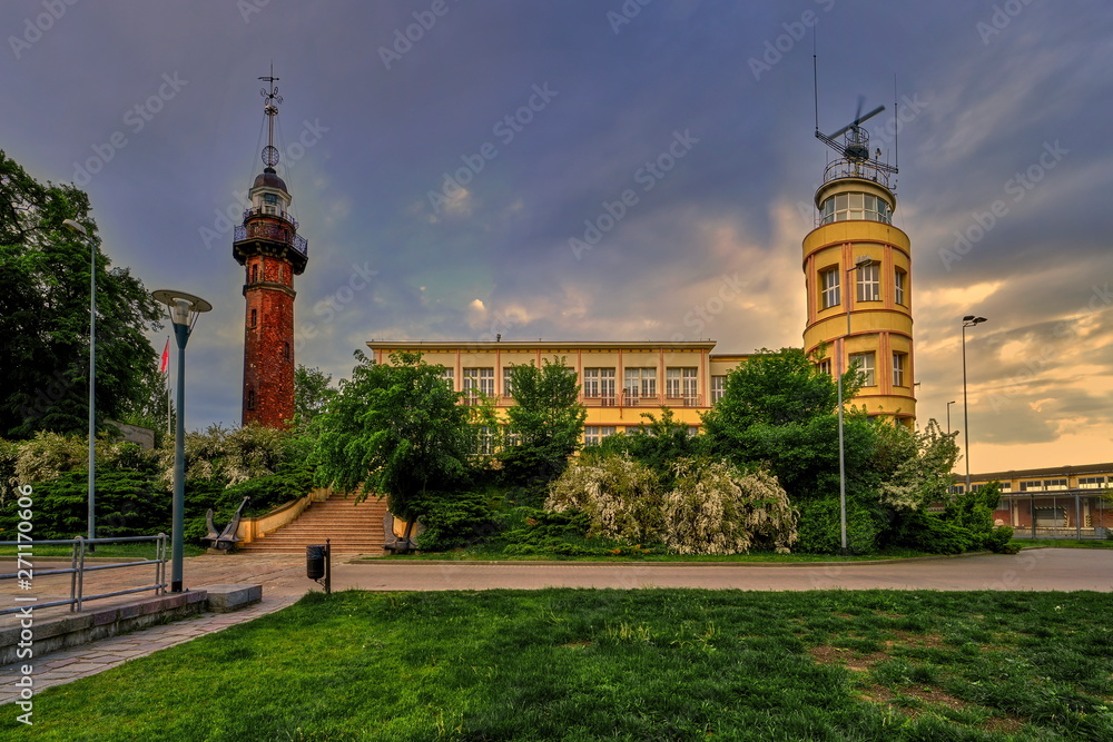 Lighthouse - a historic lighthouse on the Polish coast of the Baltic Sea, located in the Nowy Port district of the city of Gdańsk, Poland.  - obrazy, fototapety, plakaty 