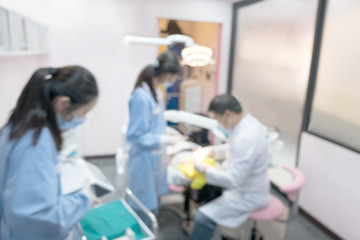 Wall Mural - Blurred image photo of dentist and his assistant are working in clinic.