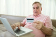 © DragonImages - Confused senior man trying to pay for his online purchase with credit card