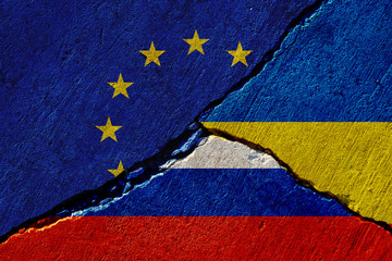 cracked concrete wall with painted eu, russia and ukraine flags