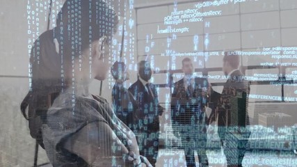 Business woman watching a group of business people in an office