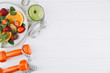 © anatoliycherkas - Diet plan, menu or program, tape measure, water, dumbbells and diet food of fresh fruits on white background, weight loss and detox concept, top view
