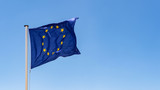 Fototapeta  - European Union Flag waving in the wind with a clear blue sky background