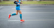 © lzf - Marathon runner legs running on city road