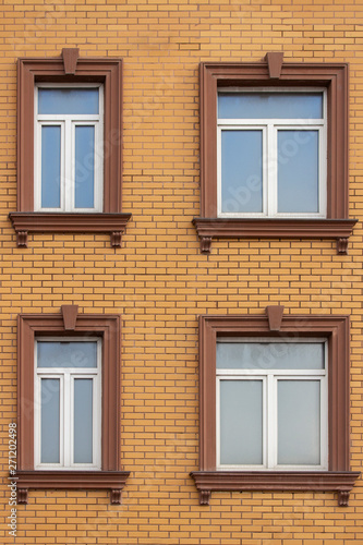 4 Plastic Windows In The Brick House Of Yellow Bricks Beautiful Windows With Moldings And Brown Trim Modern Design Of Windows Construction Of Residential Buildings Buy This Stock Photo And Explore