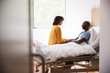© Monkey Business - Wife Visiting And Talking With Patient Husband In Hospital Bed