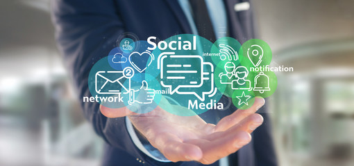 Businessman holding a cloud of social media network icon