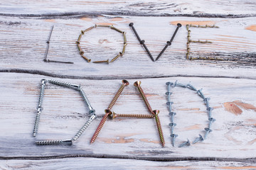 Wall Mural - Text LOVE DAD on wooden background. Decoration from metal screws and nails for Fathers Day.