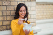 © bnenin - Student girl eating takeaway lunch outdoors.