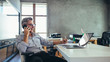 © Jacob Lund - Businessman in office talking on phone
