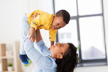childhood, kids and people concept - happy african american mother with her baby son at home