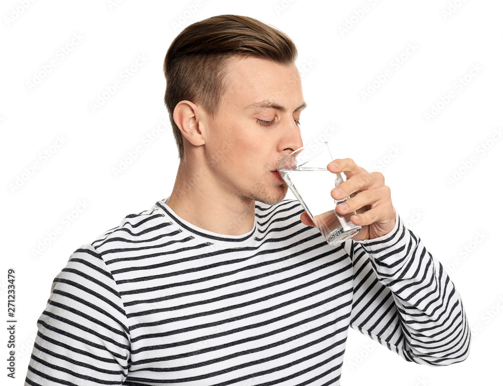 Handsome young man drinking water on white background