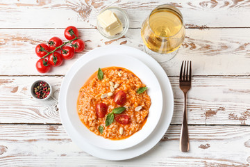 Plate with tasty risotto on wooden table