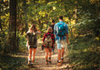 © Zoran Zeremski - Group of four friends having fun hiking through forest together.
