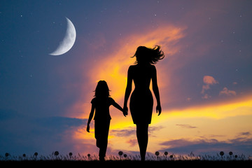 Canvas Print - mom walks with her daughter at sunset