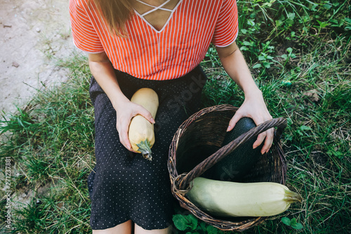 Beautiful Girl In Old Rustic Clothes Is Sitting On Green Grass