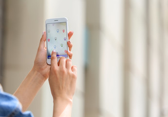 Wall Mural - Woman using mobile phone for navigation outdoors