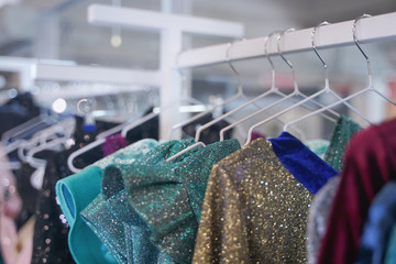 fashion stylish clothes hanging on hangers in the store. nobody.