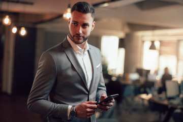 Portrait of attractive businessman in gray suit