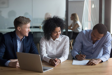 Poster - African American man signing contract with business partners at meeting