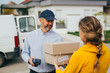 © cherryandbees - woman receiving a parcel boxes from post express courier