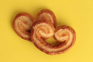 Puff pastry cookies on colorful background