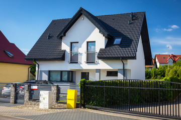 New house with white walls and black roof tiles