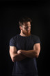© Curto - portrait of a man look to the side and with arms crossed and black background