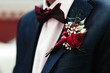 Groom's boutonniere on the jacket red red rose