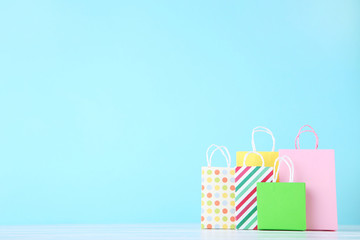 Small paper shopping bags on blue background