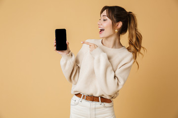 beautiful young woman wearing sweater standing