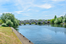 A View Of Chersey Bridge From Along The Embankment On A Summer Day