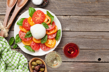 Wall Mural - Caprese salad with rose and white wine