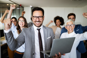 Business team celebrating a good job in the office