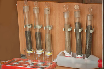 Soil experiments at the scientific fair. Test tubes with soil samples. An overview of the blurring of rocks by groundwaters.