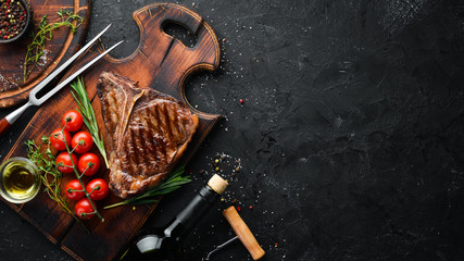 Wall Mural - Grilled Steak on a stone table. Top view. Free space for text.