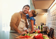 © JenkoAtaman - happy family father with child daughter preparing vegetable salad .