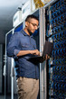 © pressmaster - Concentrated network engineer examining database server