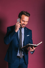 Wall Mural - Man with mobile phone and a notebook