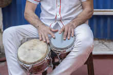 Salsa Musician Playing The Bongos, A Percussion Instrument Traditional For The Caribbean And Latin American Music