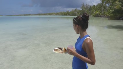 Wall Mural - Polynesian fish barbecue traditional French Polynesia food on the beach looking at shark - motu picnic cruise tour in Fakarava, Tahiti, French Polynesia. Grilled fish, coconut bread, tahitian rice.