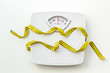 © 9dreamstudio - Diet concept with scale and measuring tape for weight loss on white background top view