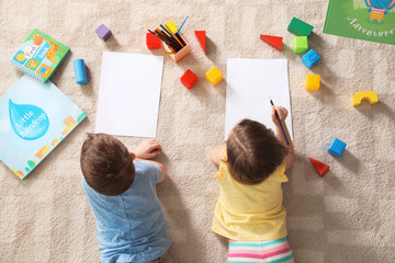 Poster - Little children drawing indoors, top view. Learning and playing