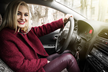 Attractive young business woman driving a car