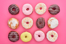 Top View Of Tasty Glazed Doughnuts On Pink Background
